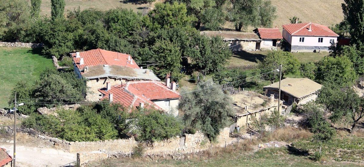 an aerial view of a house surrounded by trees