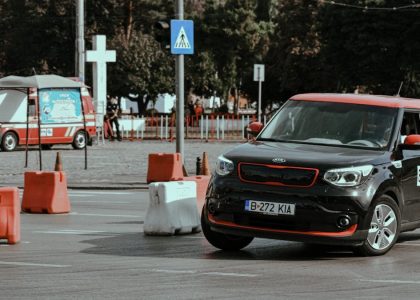 Black car driving fast and turning in drift while taking part in urban rally racing